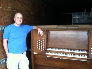 Pastor Appel next to the original console, definitely not guilty of despising the day of small beginnings 
